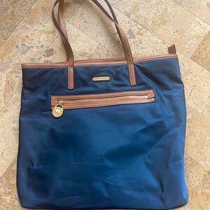 Navy blue Michael Kors Tote Bag. Gold hardware. Camel trim.